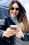 Beautiful Young Woman Using Her Mobile Phone In The Car Stock Photo