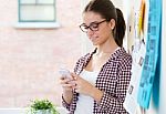 Beautiful Young Woman Using Her Mobile Phone In The Office Stock Photo