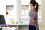 Beautiful Young Woman Using Her Mobile Phone In The Office Stock Photo