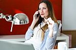 Beautiful Young Woman Using Her Mobile Phone In The Office Stock Photo