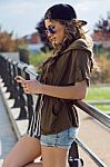 Beautiful Young Woman Using Her Mobile Phone In The Street Stock Photo