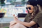 Beautiful Young Woman Using Her Mobile Phone In The Street Stock Photo