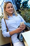 Beautiful Young Woman Using Her Mobile Phone In The Street Stock Photo