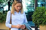 Beautiful Young Woman Using Her Mobile Phone In The Street Stock Photo