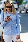 Beautiful Young Woman Using Her Mobile Phone In The Street Stock Photo