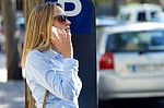 Beautiful Young Woman Using Her Mobile Phone In The Street Stock Photo