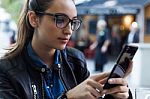 Beautiful Young Woman Using Her Mobile Phone In The Street Stock Photo