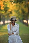 Beautiful Young Woman Wearing Sun Glassea Nd Straw Hat Talking O Stock Photo