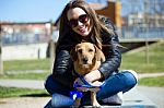 Beautiful Young Woman With Her Dog Walking In The Park Stock Photo