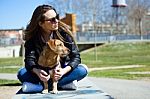 Beautiful Young Woman With Her Dog Walking In The Park Stock Photo