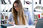 Beautiful Young Woman Working In Her Office Stock Photo