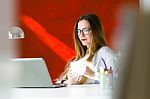 Beautiful Young Woman Working With Laptop In Her Office Stock Photo