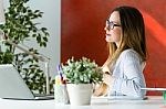 Beautiful Young Woman Working With Laptop In Her Office Stock Photo