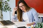 Beautiful Young Woman Working With Laptop In Her Office Stock Photo