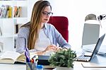 Beautiful Young Woman Working With Laptop In Her Office Stock Photo