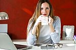 Beautiful Young Woman Working With Laptop In Her Office Stock Photo