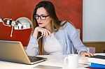 Beautiful Young Woman Working With Laptop In Her Office Stock Photo