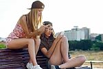 Beautiful Young Women Using Mobile Phone In The Street Stock Photo