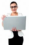 Bespectacled Woman Holding A Laptop Stock Photo