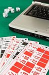 Bingo Cards On Casino Baize And A Laptop Stock Photo