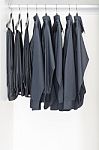 Black Clothes Hanging On Rail Stock Photo