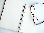 Blank Page Of A Notebook And Eyeglasses Stock Photo