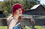 Blonde Female In Red Hat On Farm Stock Photo