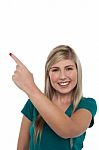 Blonde Girl Pointing Away On White Background Stock Photo