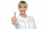 Blonde Woman In Formal Attire Showing Thumbs Up Gesture Stock Photo