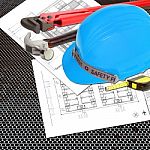 Blue Helmet Of Foreman Or Guest Constructor With Blueprints Stock Photo