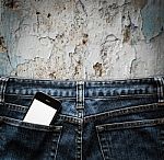 Blue Jeans With Cell Phone In A Pocket Background Stock Photo