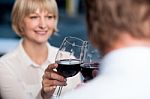 Blur Images Of Couple Raises A Glass Of Red Wine Stock Photo