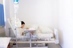 Blurred Image Of Patient With Drip In Hospital For Background Us Stock Photo