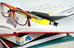 Book Stack With Glasses And Calculator Stock Photo