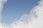 Border Of Bubble Foam Soap In Blue Water Stock Photo