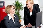 Boss Taking Help Of Her Secretary In Office Work Stock Photo