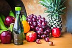 Bottles Of Juice And Fruits On A Table Stock Photo