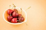 Bowl Of Cherries On Warm Vintage Background Stock Photo