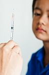 Boy And Vaccine Syringe Stock Photo