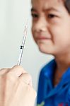 Boy And Vaccine Syringe Stock Photo