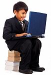 Boy Sitting On A Pile Of Books Stock Photo