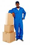 Boy Standing With Cardboard Boxes Stock Photo