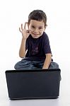 Boy With Laptop Showing Ok Gesture Stock Photo