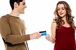 Boyfriend Handing Over Credit Card Stock Photo