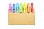 Brown Notepad With Colorful Clip On White Background Stock Photo