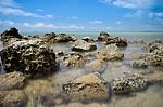 Brown Rock On Blue Sea Stock Photo