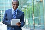 Busines Executive Smiling With Tablet Pc Stock Photo