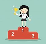 Business Concept, Business Woman Standing On The Winning Podium And Holding Trophy Stock Photo