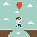 Business Concept, Businessman Flies Across A Gap To Another Cliff By Using Balloon Stock Photo