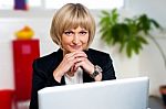 Business Executive Posing With Laptop Open At Work Desk Stock Photo